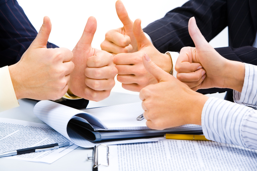 People with their thumbs up meaning a great business plan